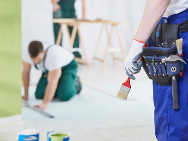 Group of specialists working by the house renovation together